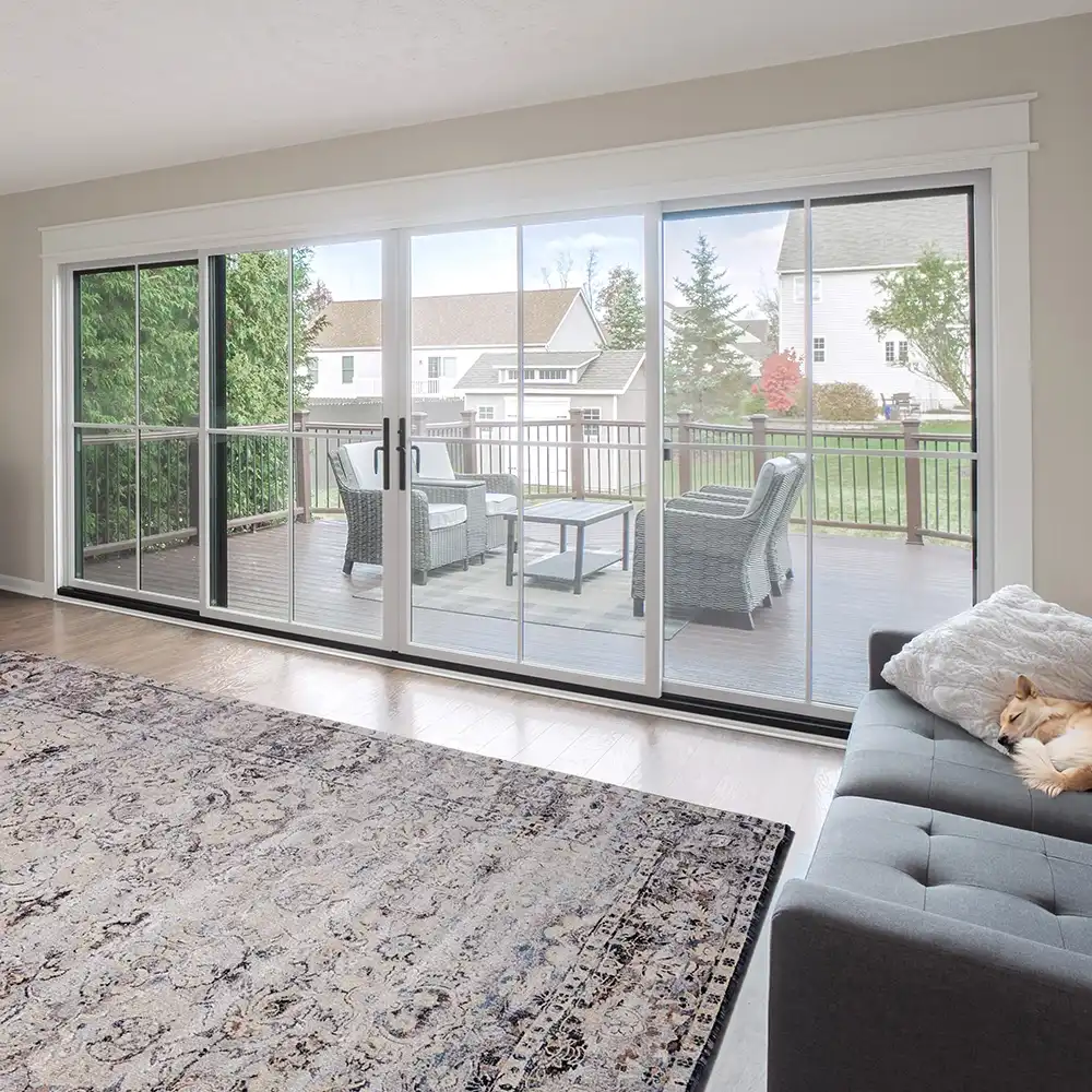 Interior view of a white four-panel Marvin Replacement sliding patio door with window grilles.